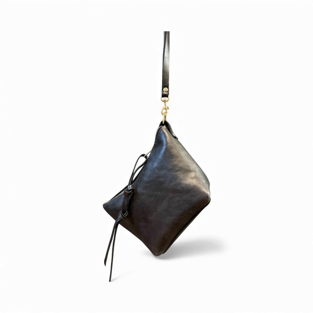 Black leather handbag with a strap on a white background